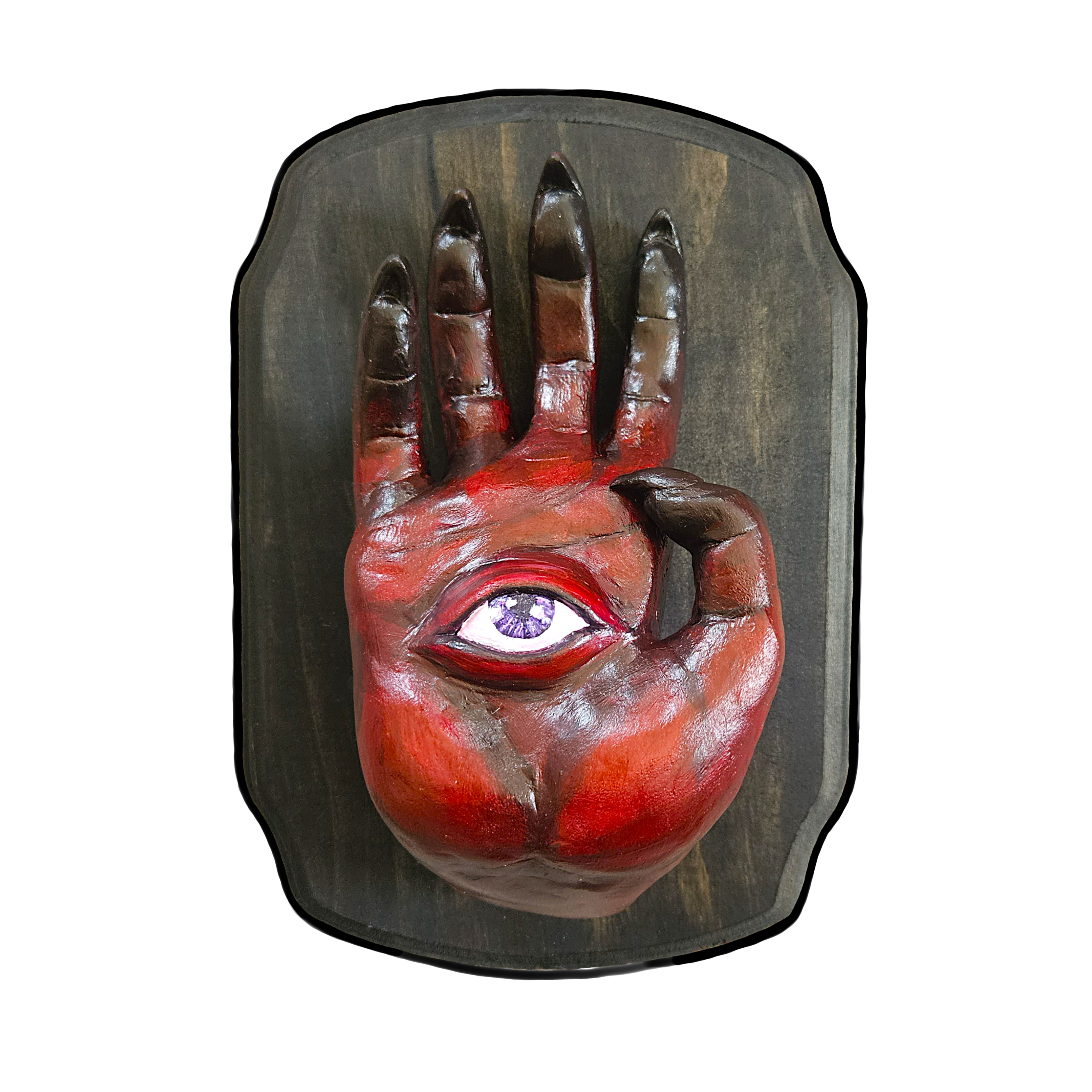  dark red demon hand sculpture with a purple eye on the palm